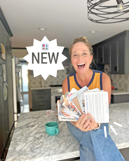 Child expert holding activity cards for kids to help with soft skills.