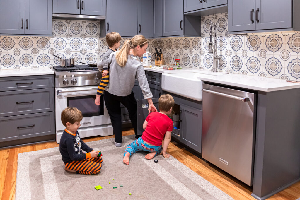 Picture of a mom with three boys trying to get breakfast ready for her kids.